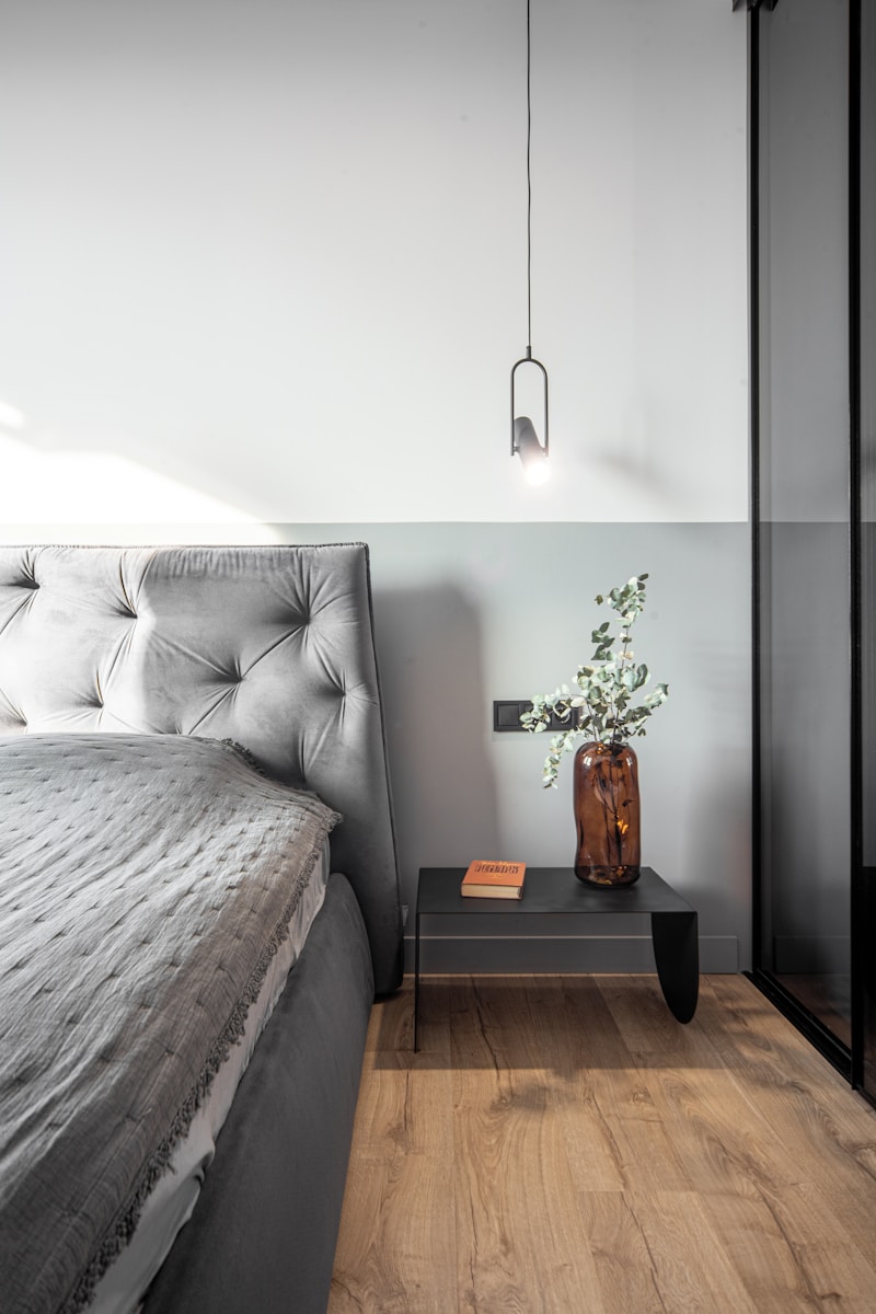 A stylish, modern bedroom features a nightstand.